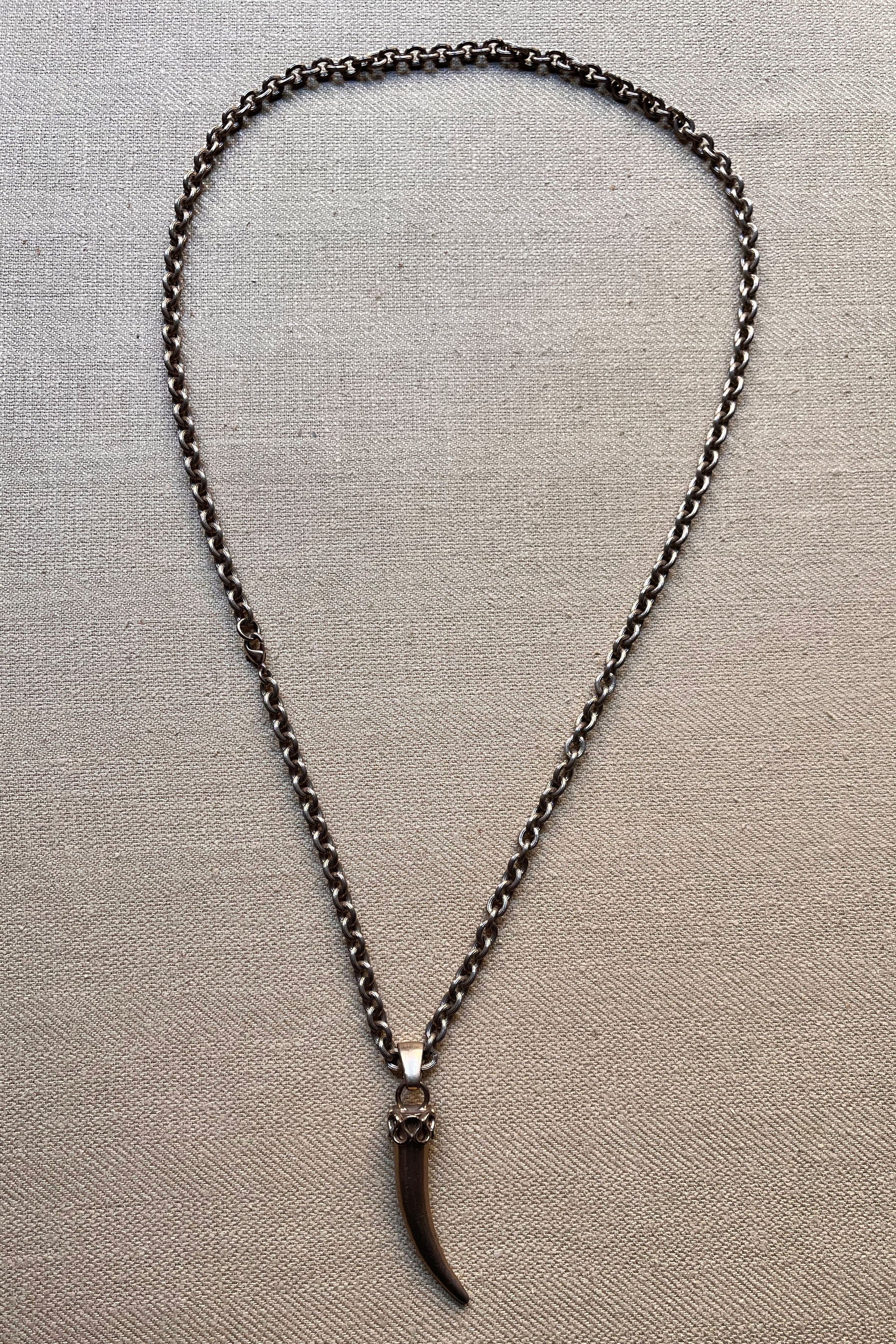 Silver tone tusk pendant necklace