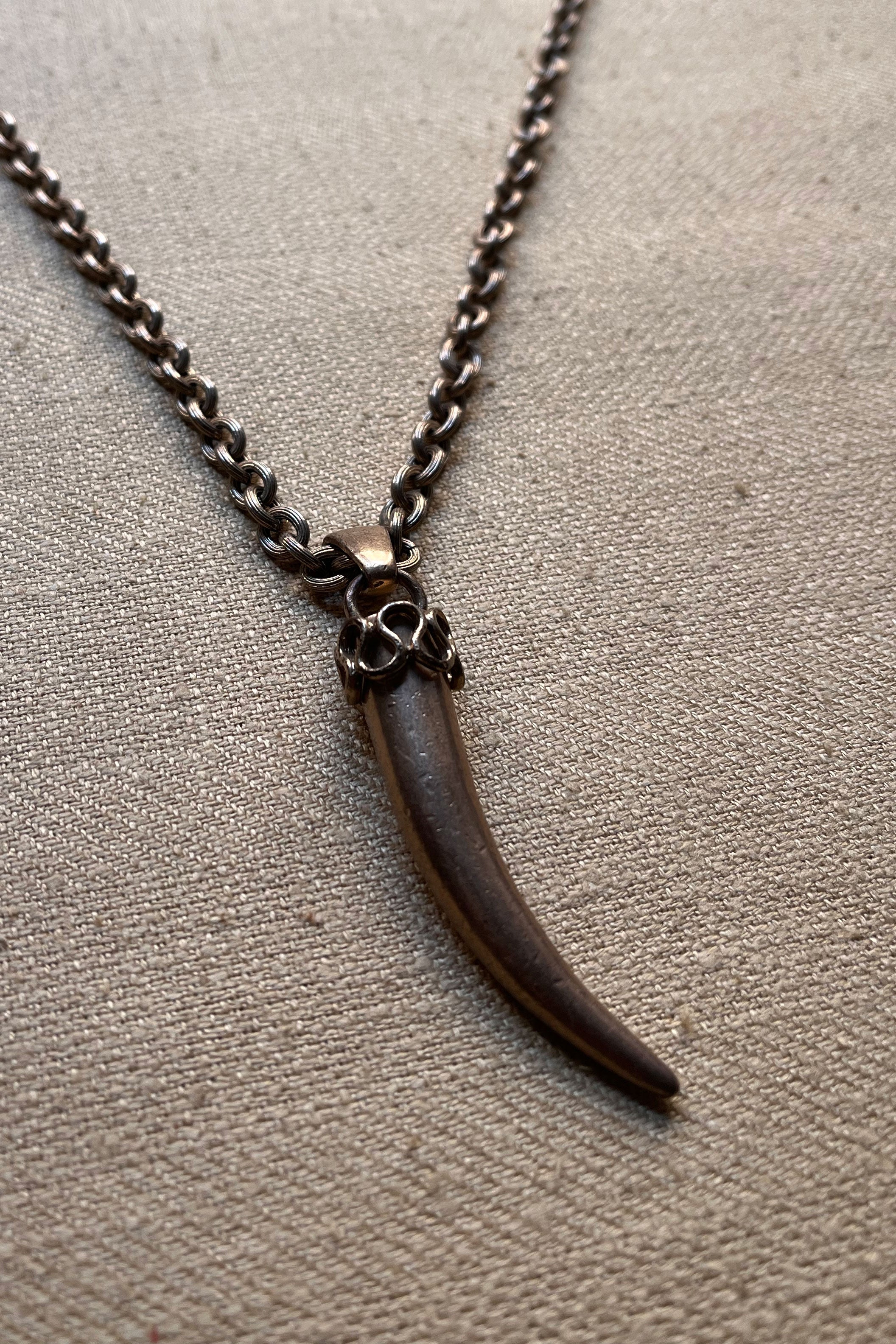 Silver tone tusk pendant necklace